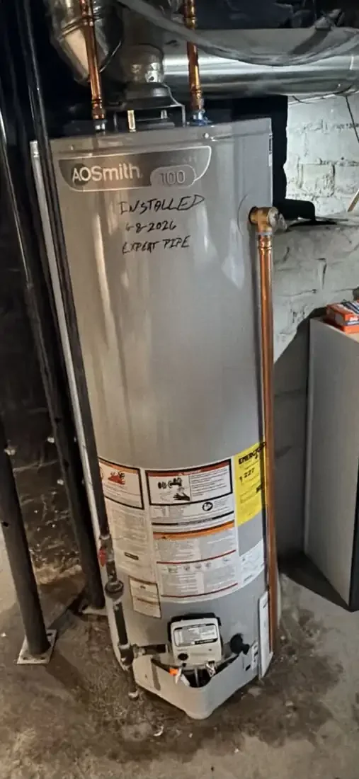 New A.O. Smith gas water heater with copper lines and relief valve discharge pipe