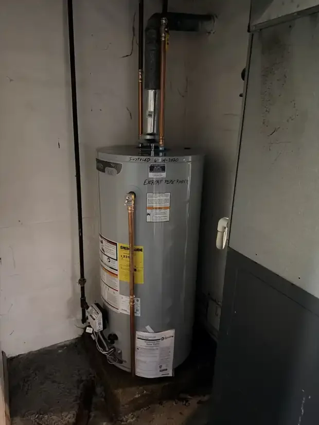 A.O. Smith gas water heater with copper supply lines, metal vent and piped relief valve