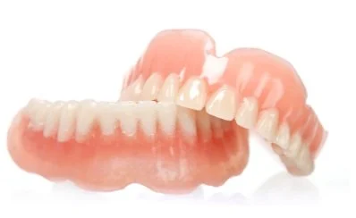 A pair of dentures with upper and lower sets of artificial teeth.