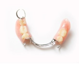 Partially assembled full dentures with artificial teeth and metal framework on a white background.