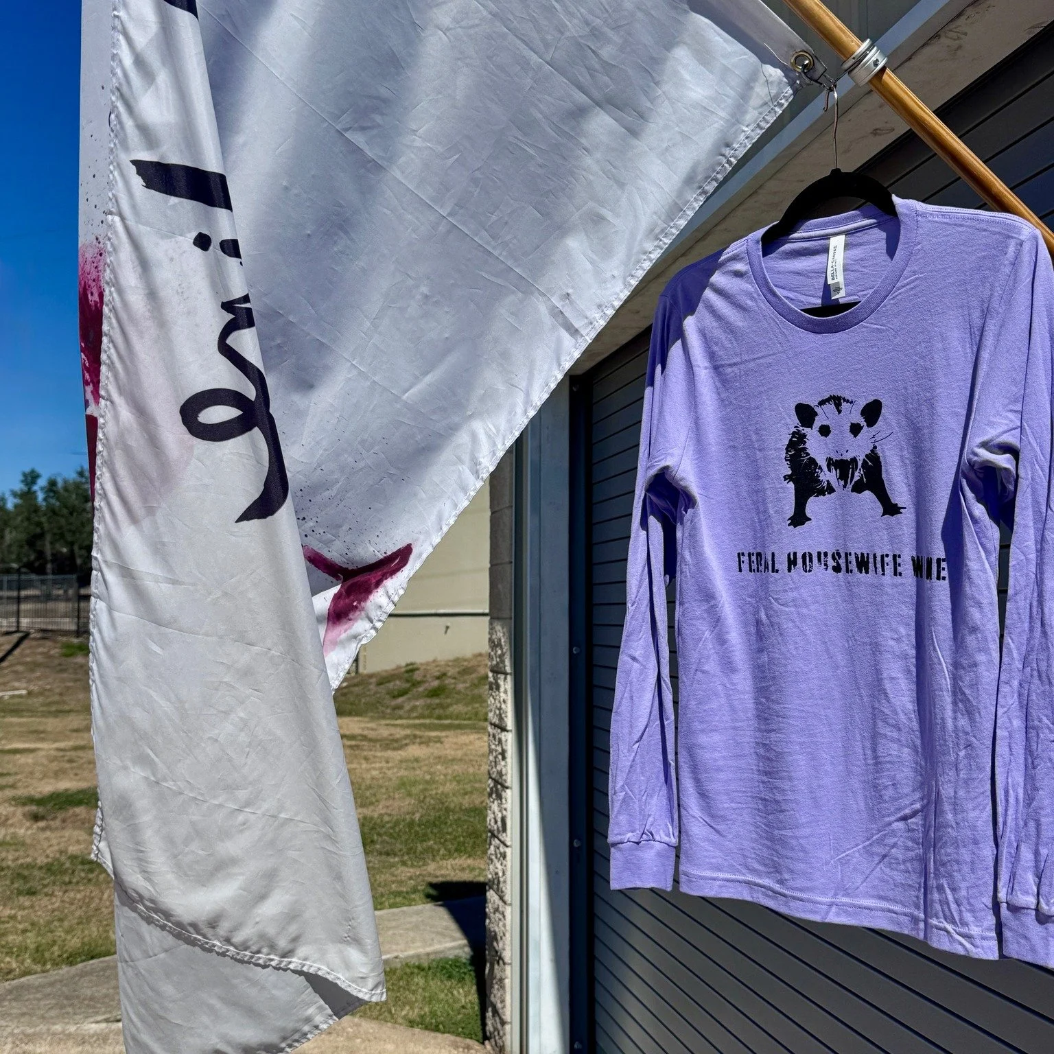 Feral Fall just dropped. 🍷💜
Our long sleeve lavender shirts are in &mdash; soft, snuggly, and ready for cooler nights and Fros&eacute;-fueled chaos.
Perfect for sipping wine, watching games, or embracing your inner feral housewife in cozy style.

L