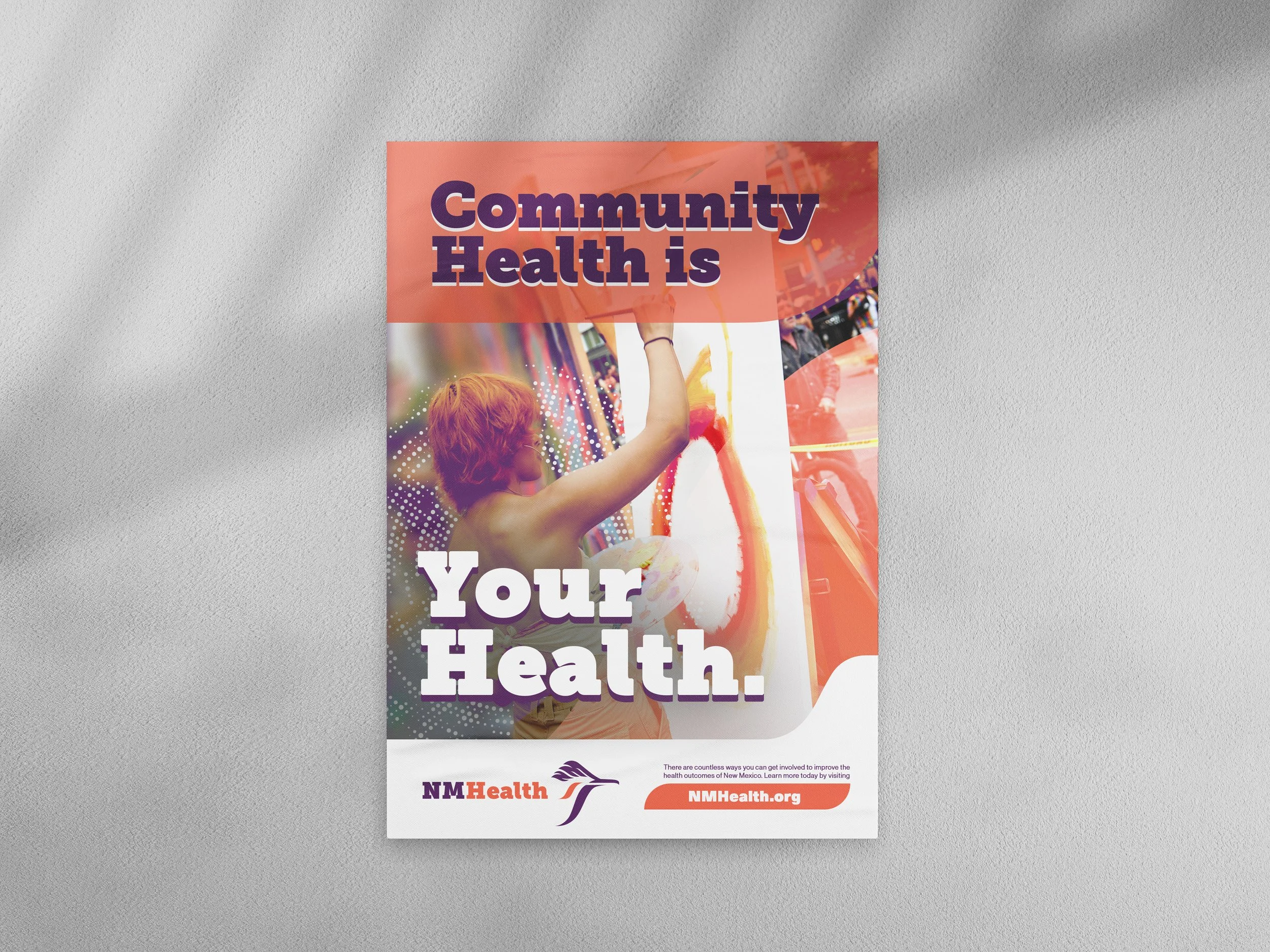Poster with a child reaching up, emphasizing community health, with text that says 'Community Health is Your Health' and logos for NMHealth and NMHealth.org at the bottom.