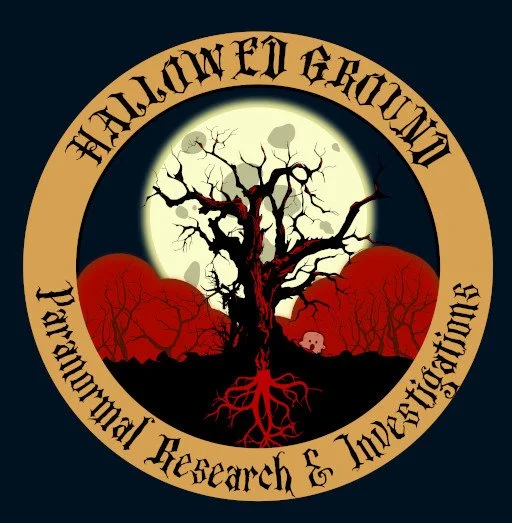 Logo for Haunted Ground Paranormal Research and Investigations. It features a crooked tree with red roots, a full moon in the background, and orange hills. Circular text around the image reads 'Haunted Ground Paranormal Research & Investigations.'