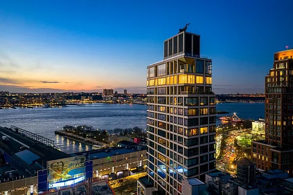 Exterior at dusk showing west Chelsea penthouse, New York, featuring lighting design by Tirschwell Lighting, designed by Tadao Ando.