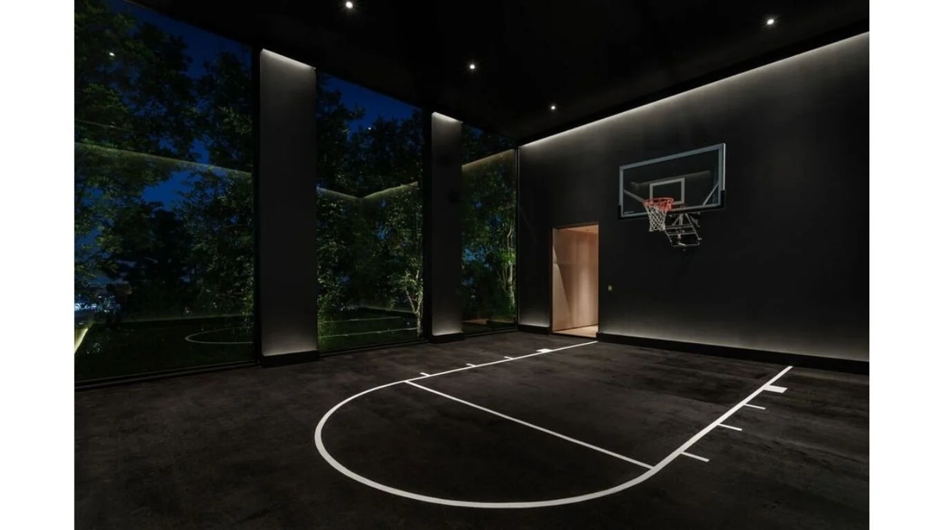 Indoor basketball court in Cordell Ave residence, Los Angeles, featuring lighting design by Tirschwell Lighting, designed by Paul McClean Design.