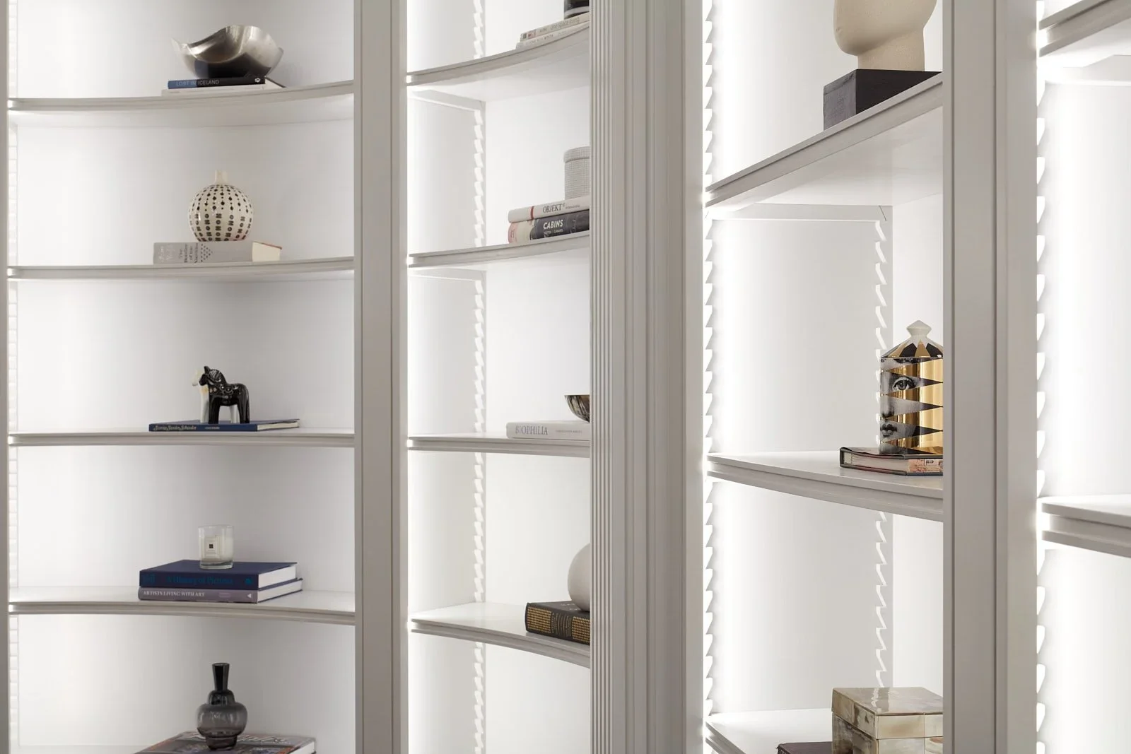 Built-in shelving display in Central Park West residence, New York, with lighting design by Tirschwell Lighting, designed by William Leeds.