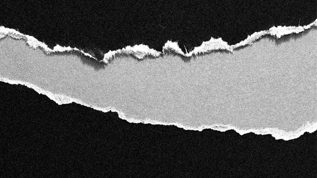A torn piece of paper with torn edges, set against a black background.