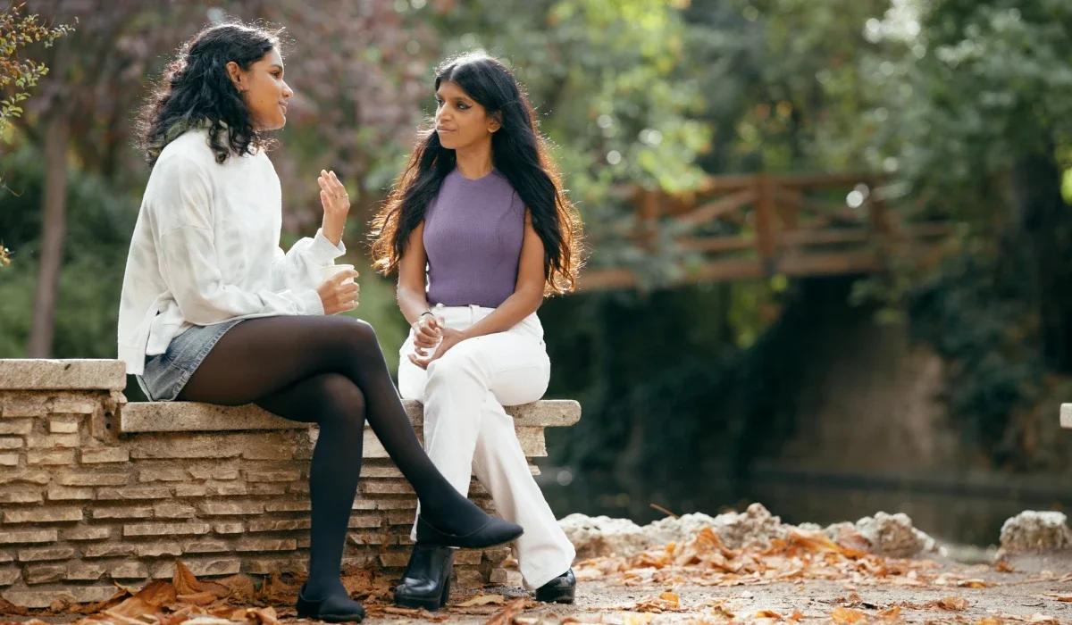 a young couple sitting in a park