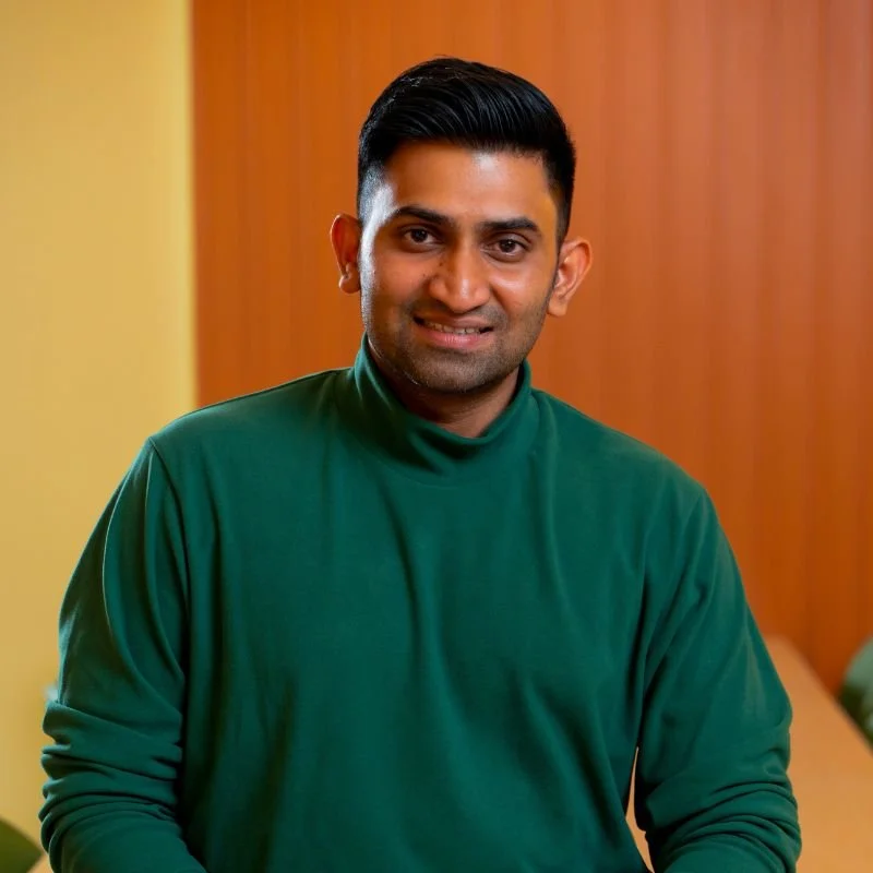 a young man of South Asian heritage posing for the camera
