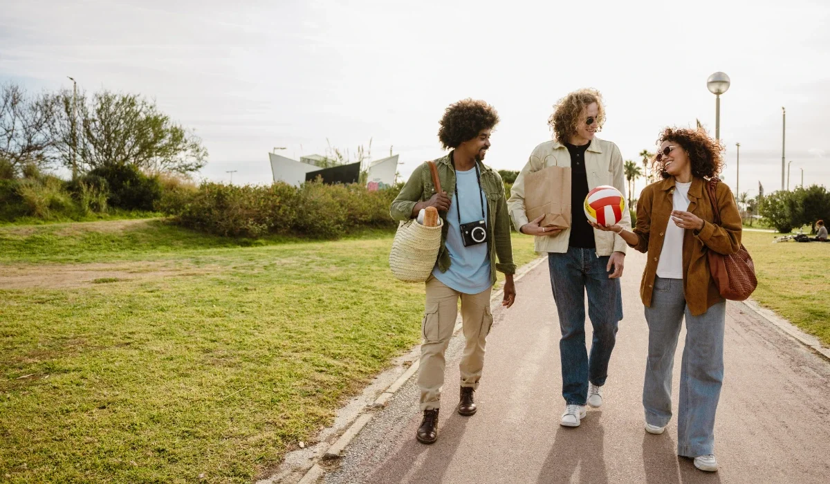 a group of friends on their way to a picnic at a park
