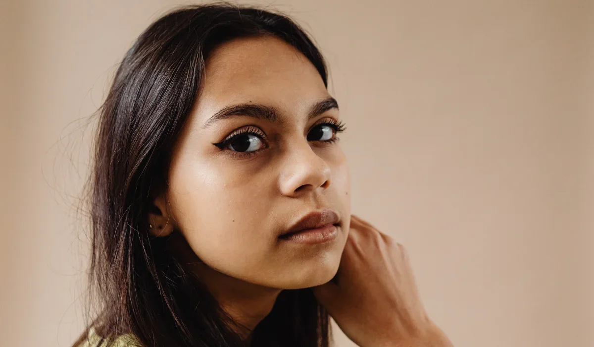 A south asian woman looking at the camera.