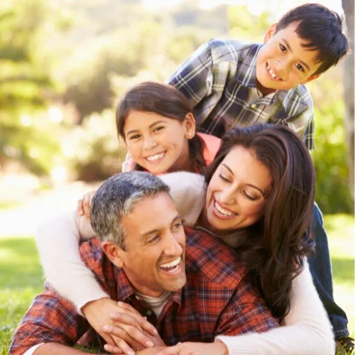 family of four with young kids at the park
