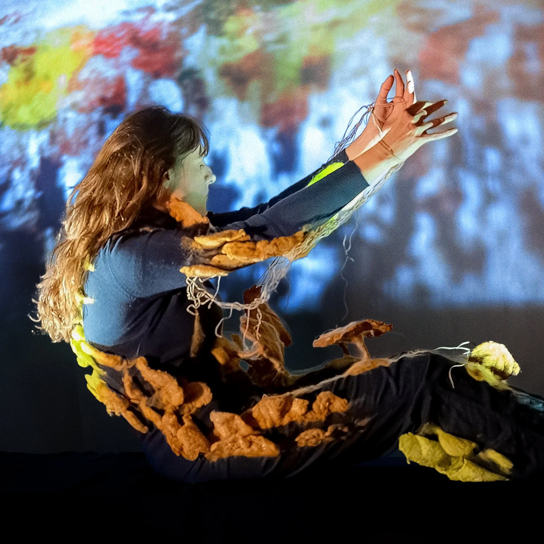 brown shelf mushrooms on wearable art piece on performance stage