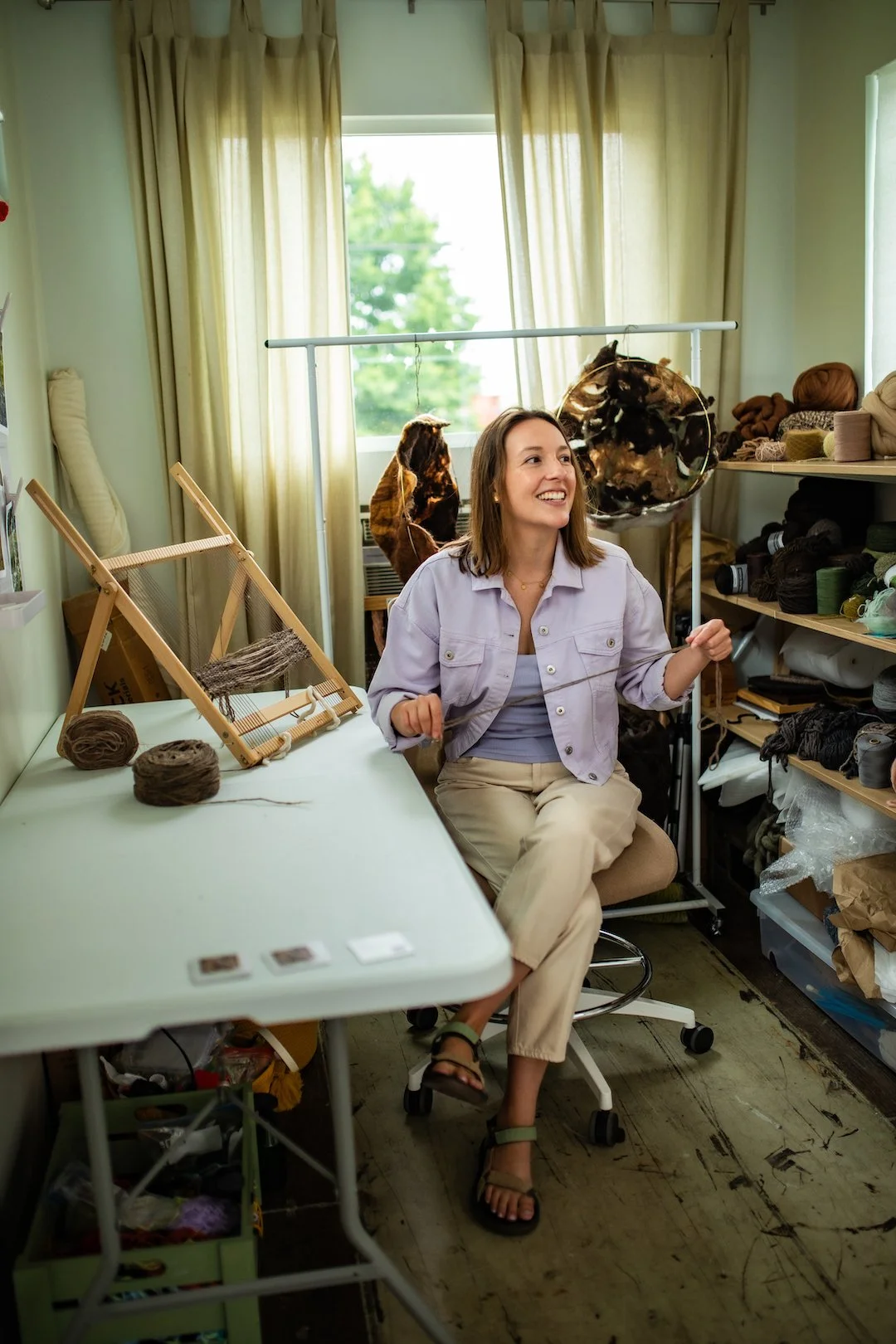 fiber artist in studio with yarn