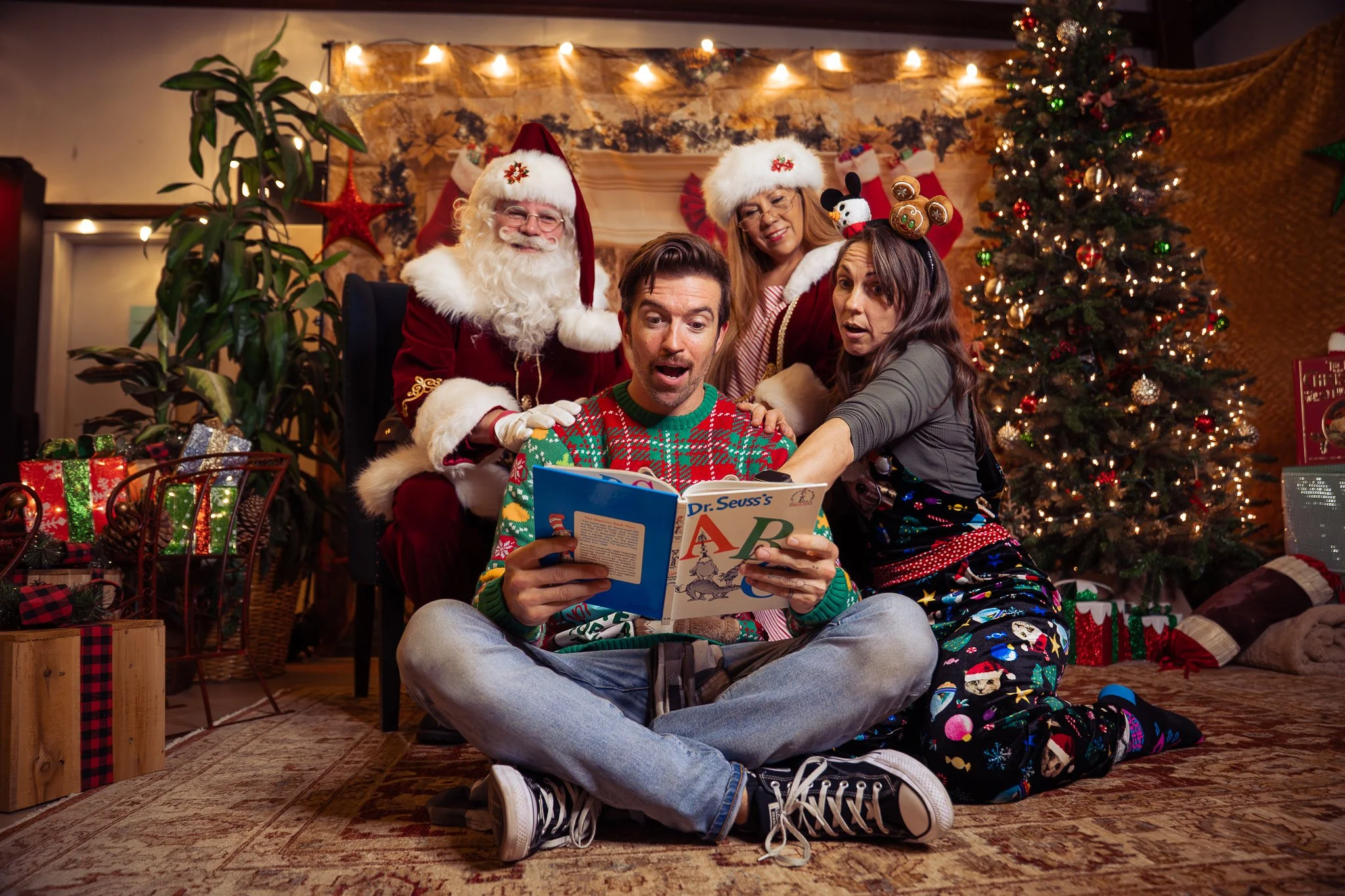 Two young children in martial arts uniforms watching a sparring match between two other children blurred in the background. Jiu Jitsu Tournament.