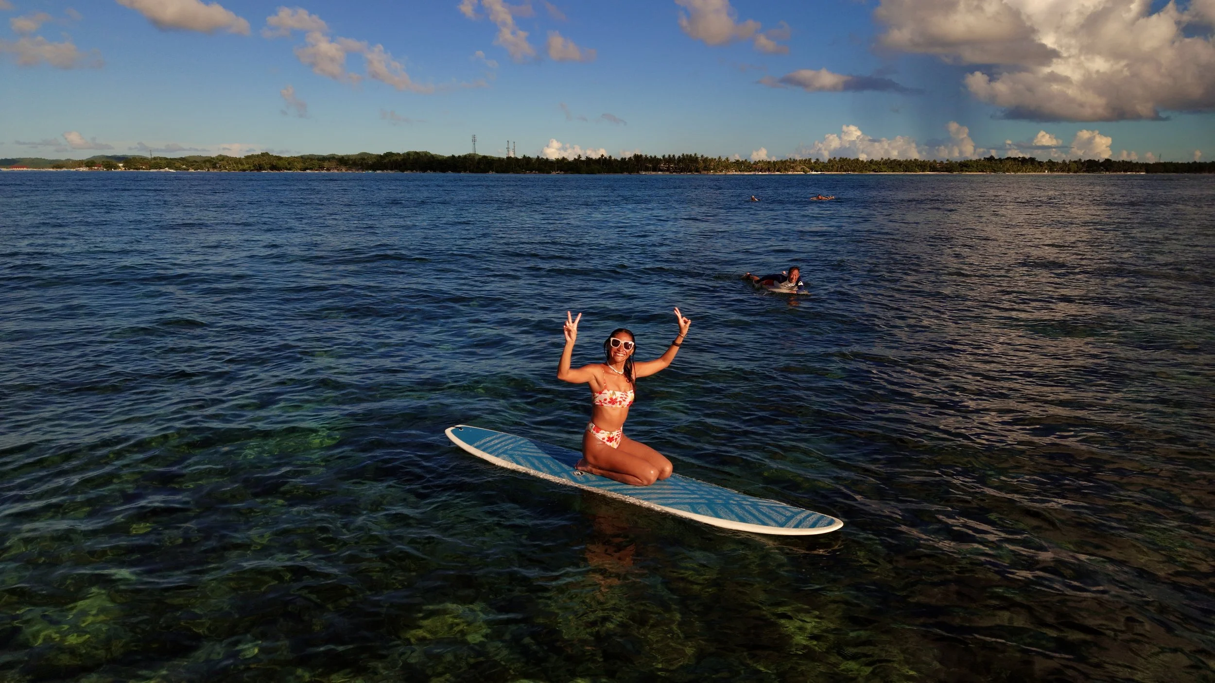luna on a surfboard at sunset 