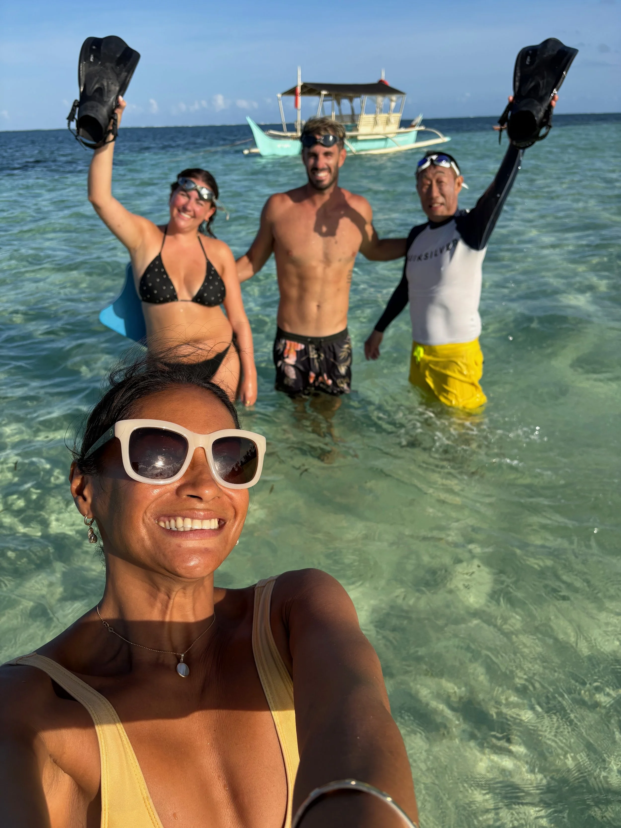 David and Luna in the sea with their guests after doing open water swimming as part of their Swimfit Siargao retreat