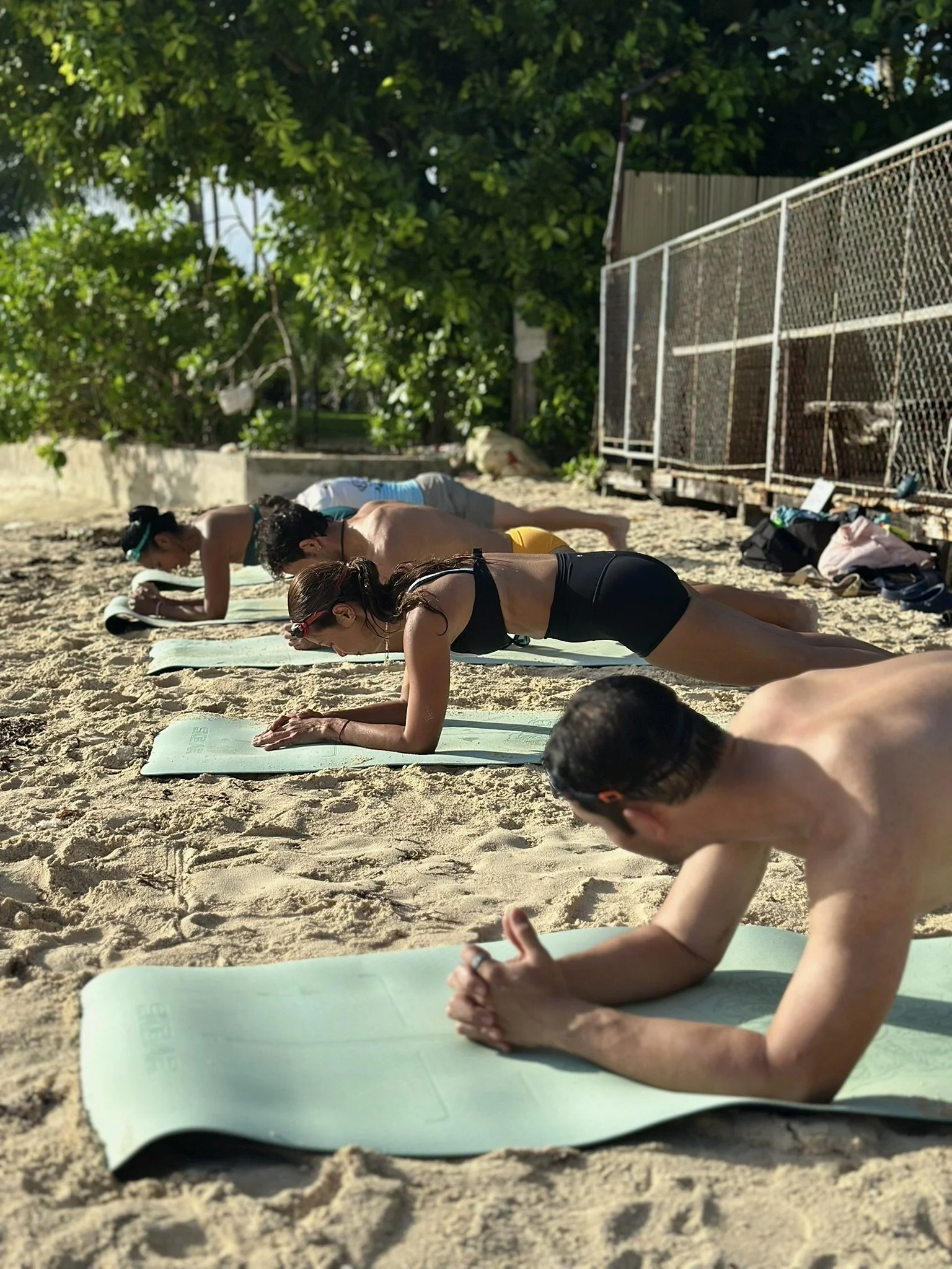 people working out on the beach as part of the swimfit siargao retreat