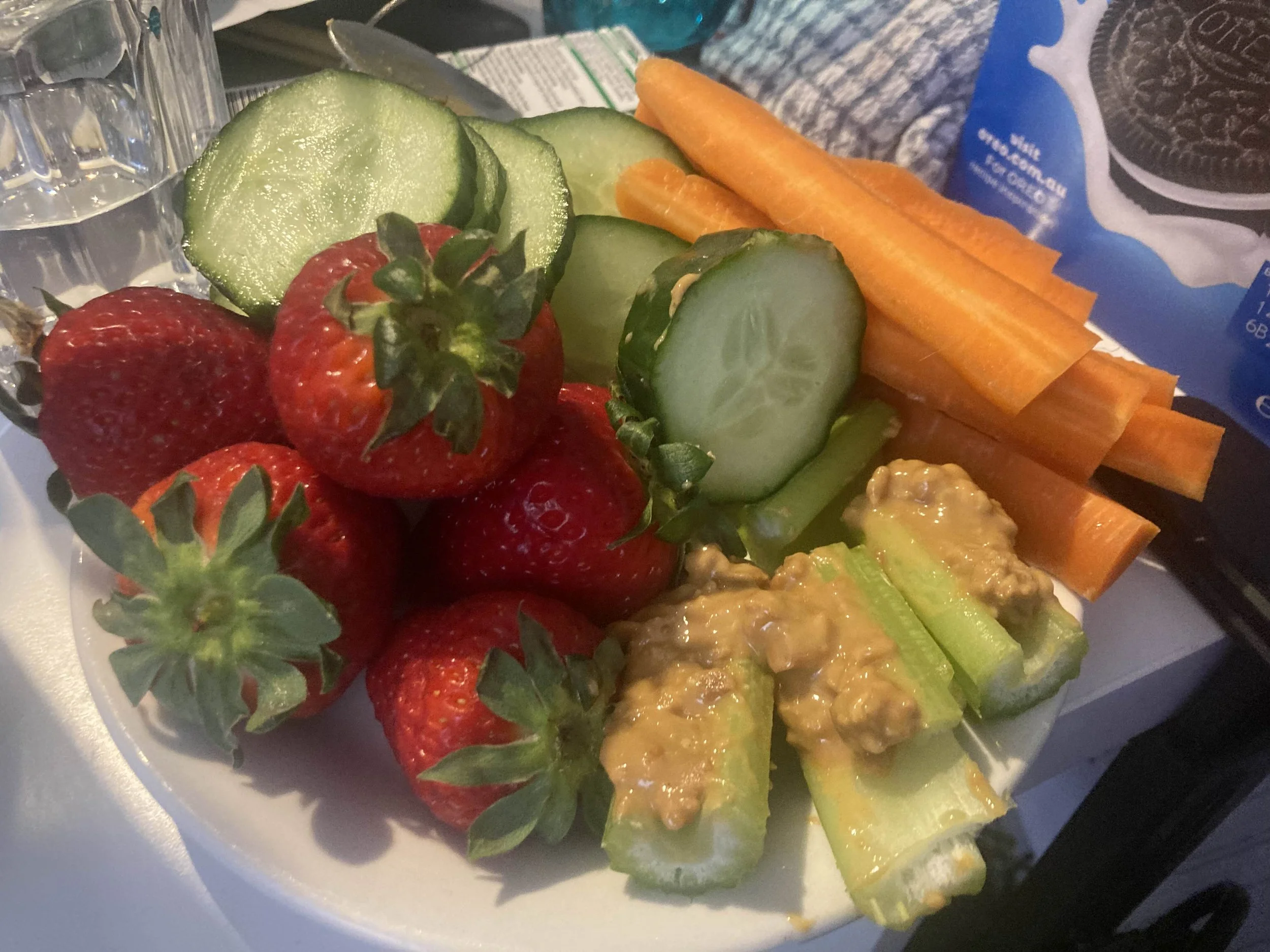 A HEALTHY MINI PLATTER ,I HAVE CELERY WITH PEANUT BUTTER ,CARROTS,CUCUMBER AND STRAWBERRIES.A VARIETY OF COLOUR INCREASE OF GOOD NUTRITION.