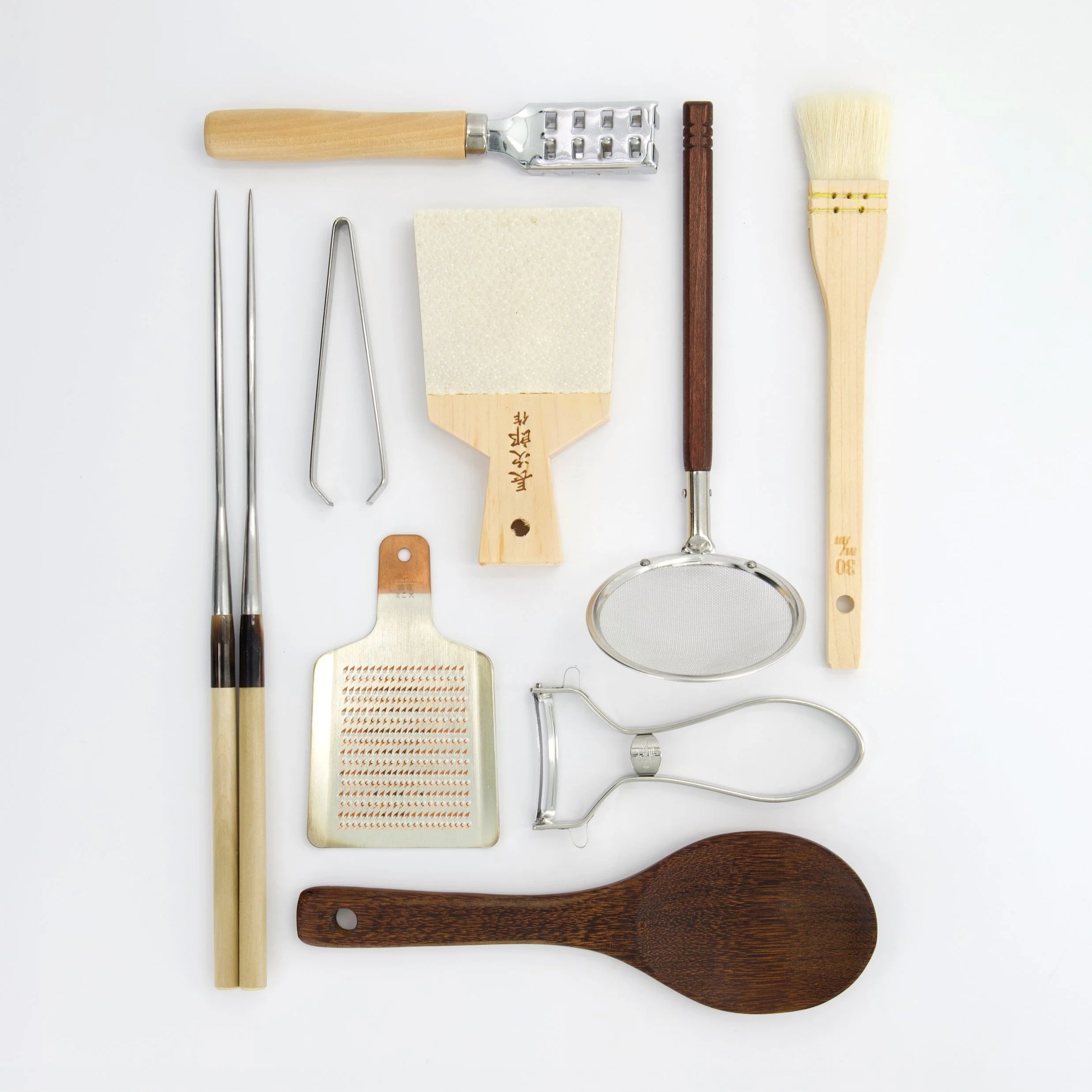 Tokyo Design Studio Japanese kitchen tools collection — stainless steel chopsticks, wooden grater, oil skimmer, pastry brush and rice paddle