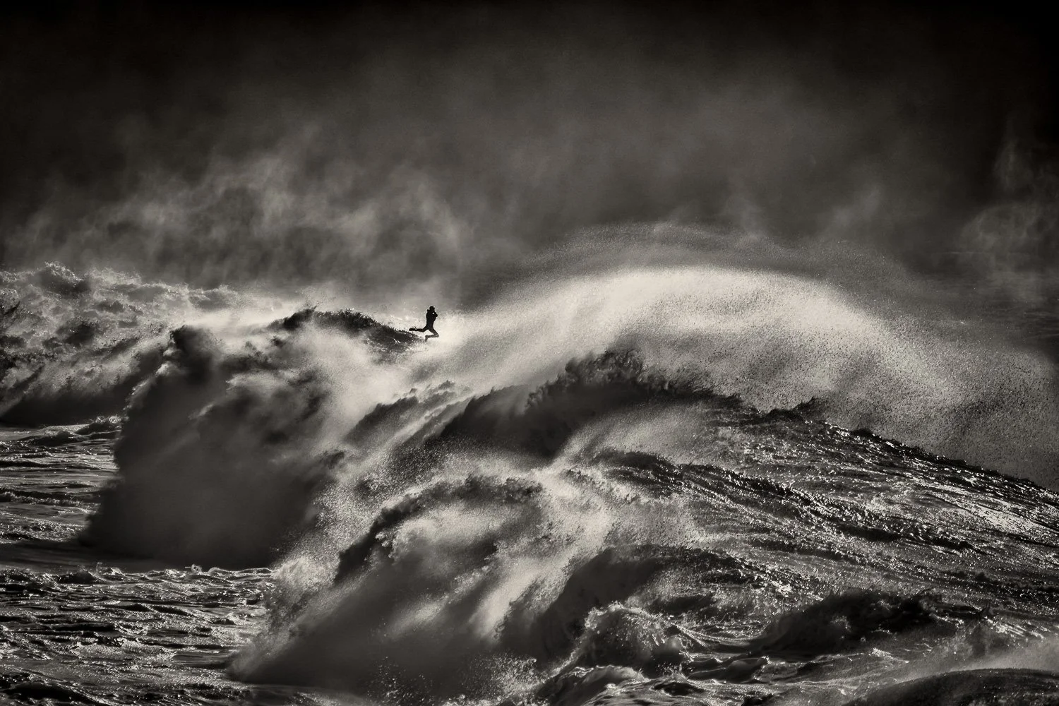 lone-surfer-fly-massive-storm-waves-ocean-photography.jpg