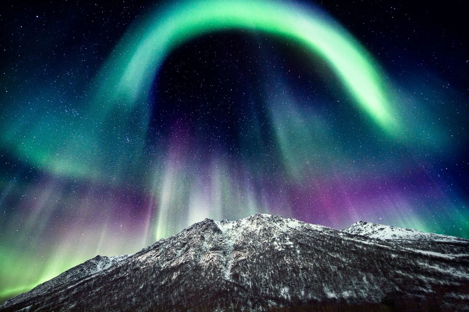northern-light-dancing-over-mountain-norway.jpg