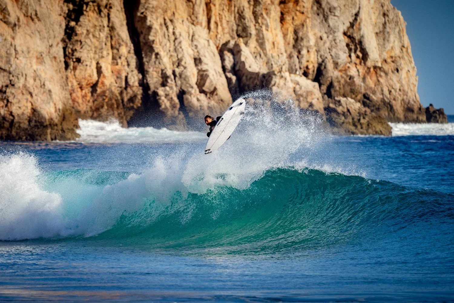 surfer-joshua-karbus-aerial-maneuver-rocky-coastline-algarve.jpg