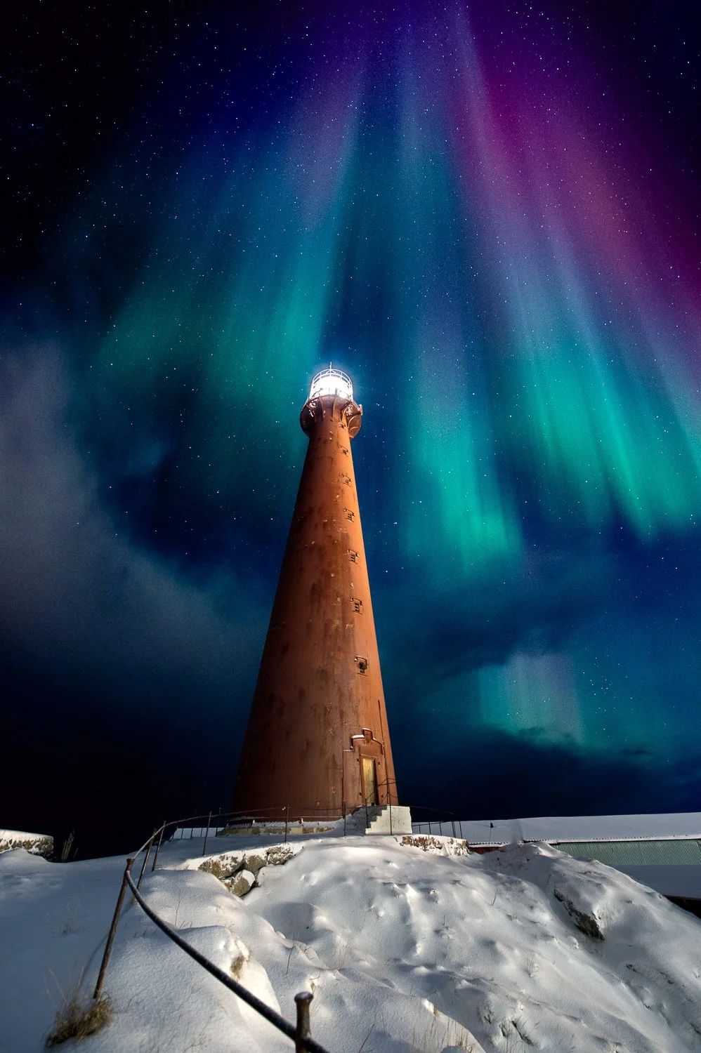 northern-light-over-lighthouse-snow-norway.jpg