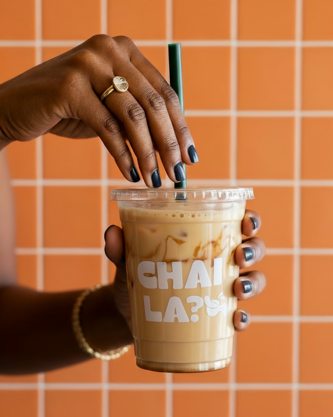 Iced chai latte in branded cup with modern cafe identity