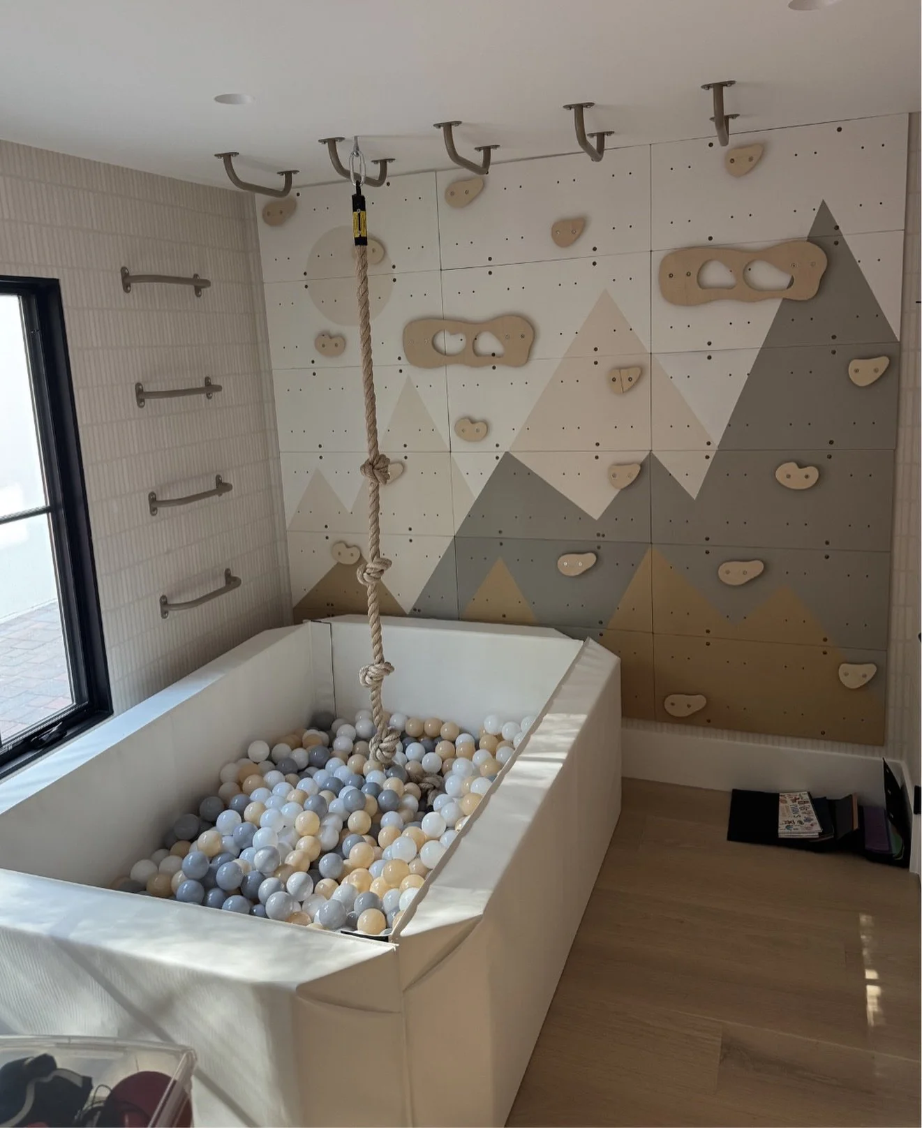 Playroom in progress 🧸 This space is all about movement + creativity. From the custom climbing wall to the rope swing and soft ball pit below, every detail was created to encourage play while still feeling thoughtful and design-forward #HillsideHide
