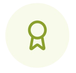 A simple icon of a gold award ribbon or medal with a circular top and a ribbon hanging below, on a white background.