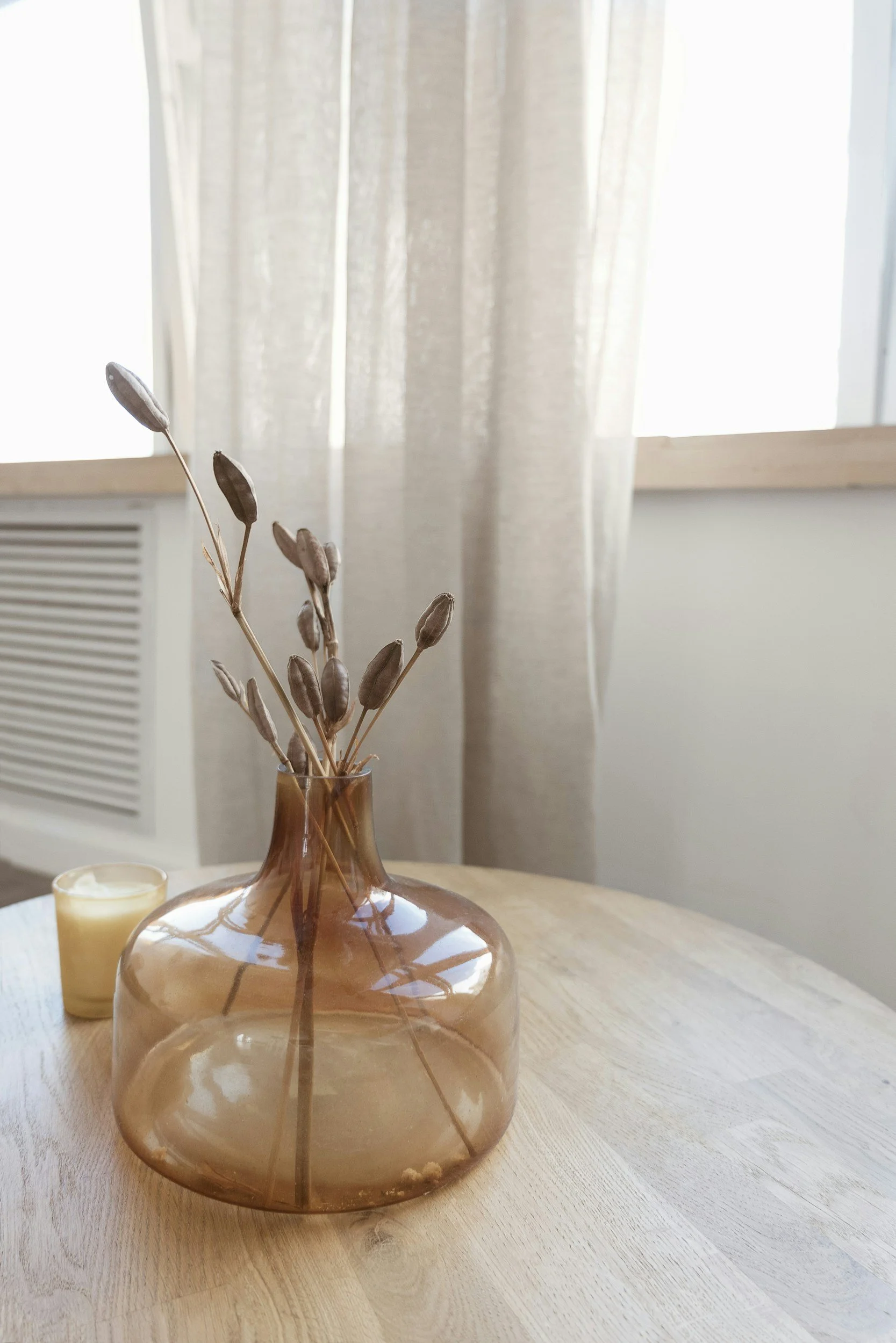 dried flowers in brown vase