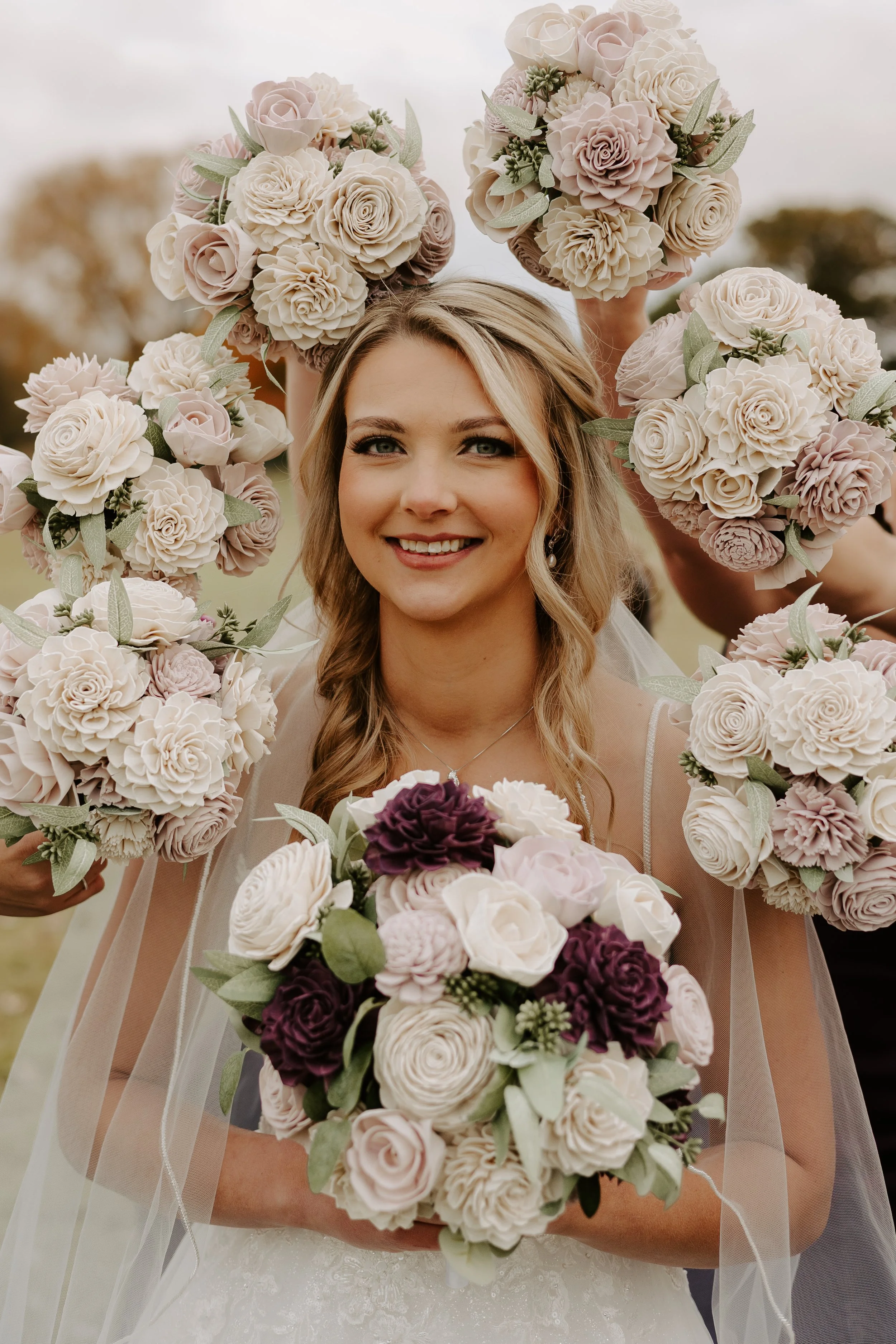 A mountain landscape with snow-capped peaks in the background and a modern wooden building on green rolling hills in the foreground.