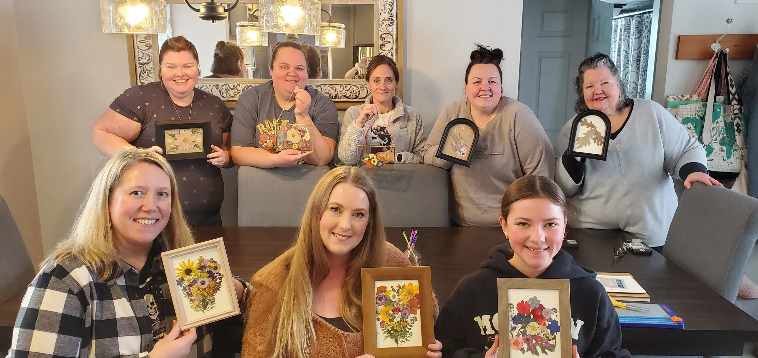 Group of women holding framed pressed flower art, Hands-on workshops that come to you. Lake Country and Milwaukee area.