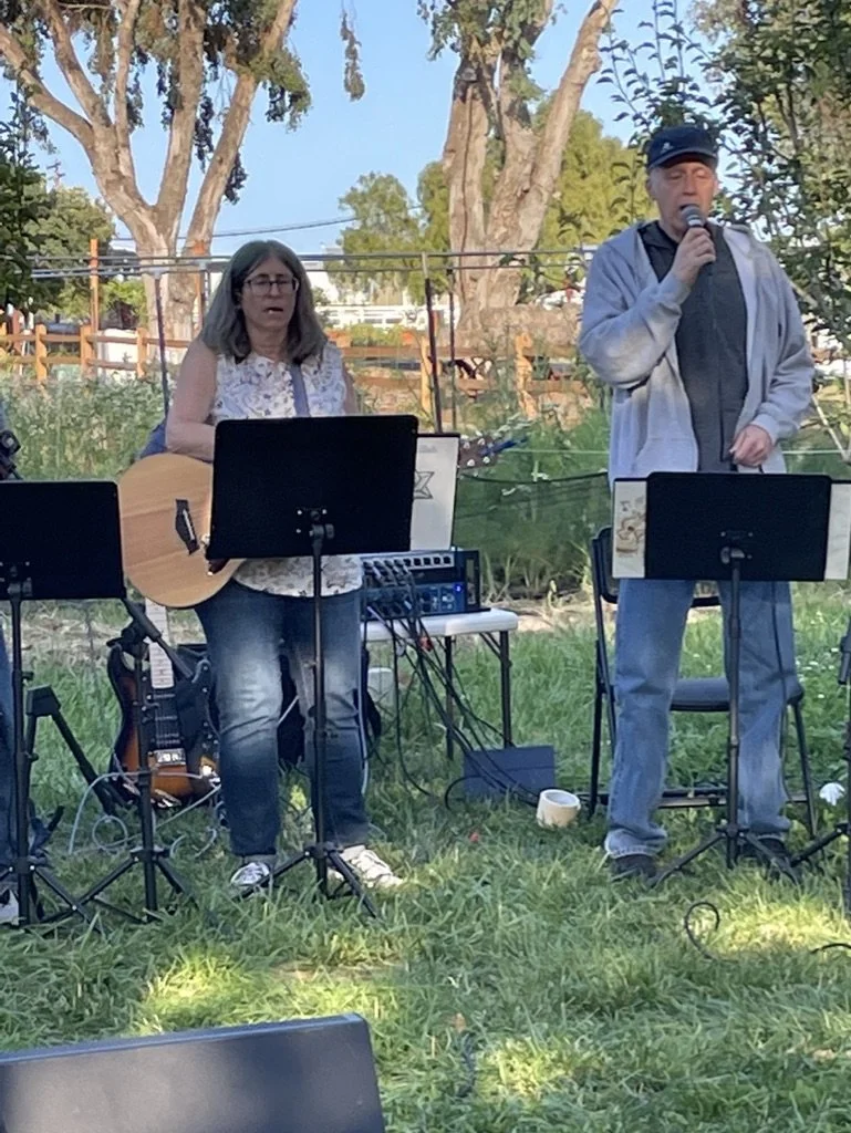 Singing joyfully at Coastal Roots Farm