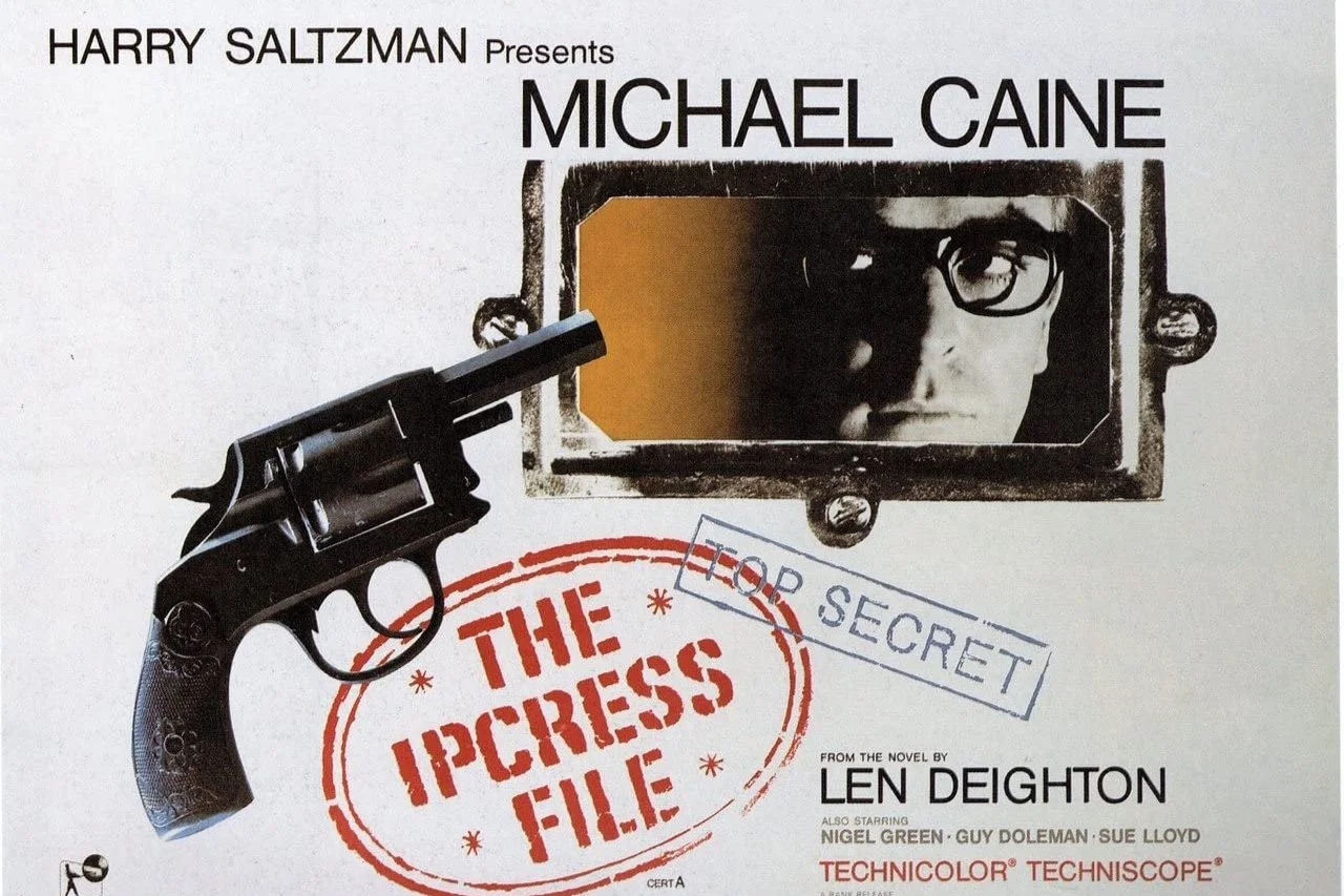 Cover of the movie 'The Ipcress File' featuring a black revolver pointing at a mirror reflecting a man's face with glasses, with text indicating the title and star Michael Caine.