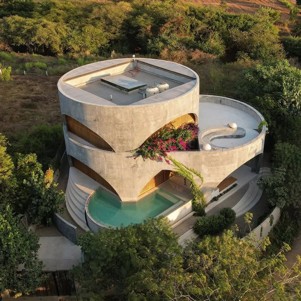 Brutalist in spirit yet poetic in form, Casa Toro rises from the rugged landscape of Oaxaca like a sculpted monument to silence and space. Carved from raw concrete and softened through sweeping arches, the home embraces a dialogue between mass and li