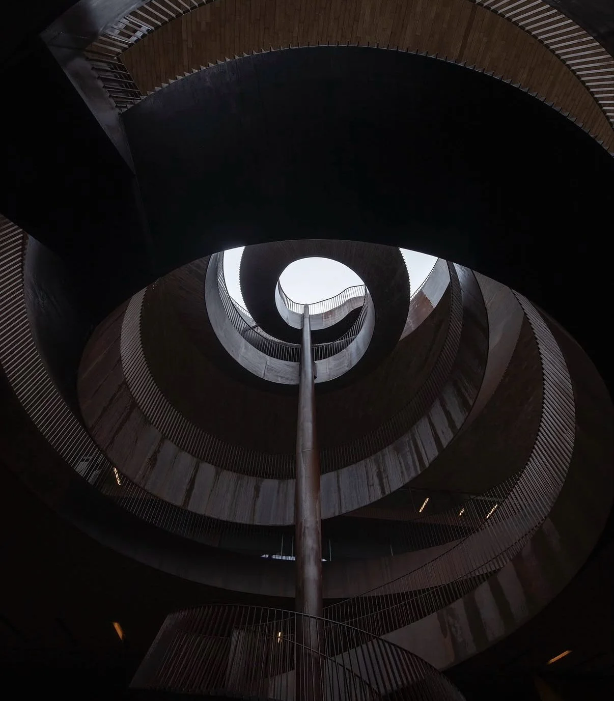 Carved into the Tuscan landscape, @marchesiantinori  winery designed by @archea_associati ￼ dissolves the boundary between architecture and terrain. Weathered corten steel spirals descend beneath vineyards and olive groves, transforming the winery in