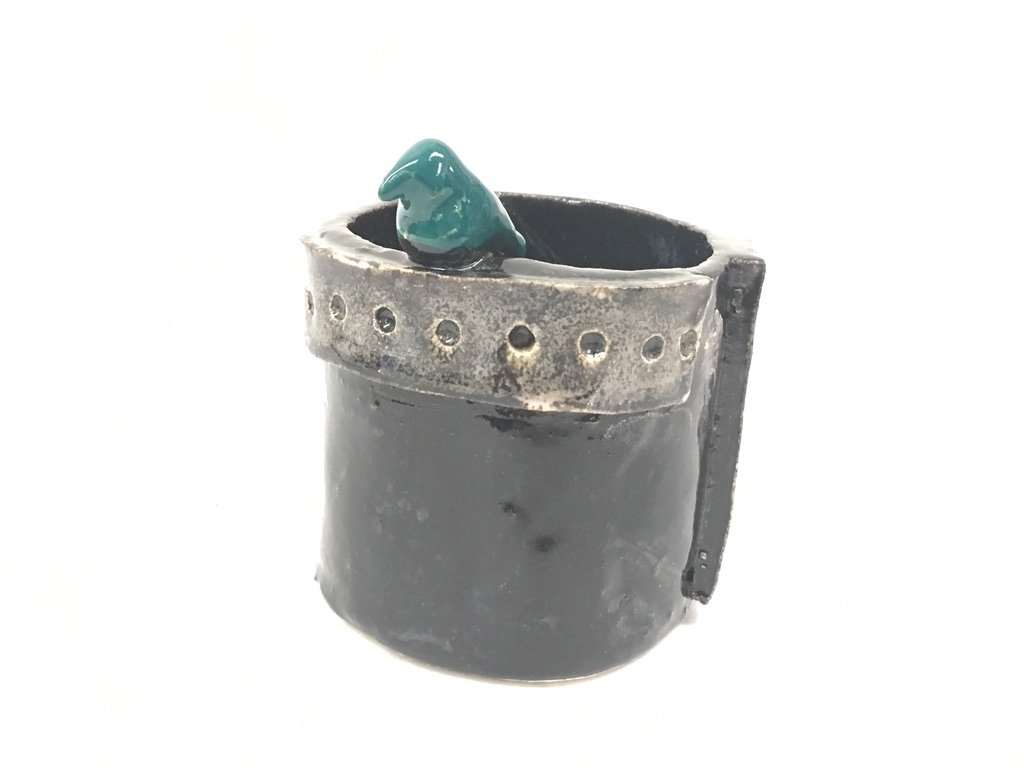 Ceramic mug with a green bird-shaped handle