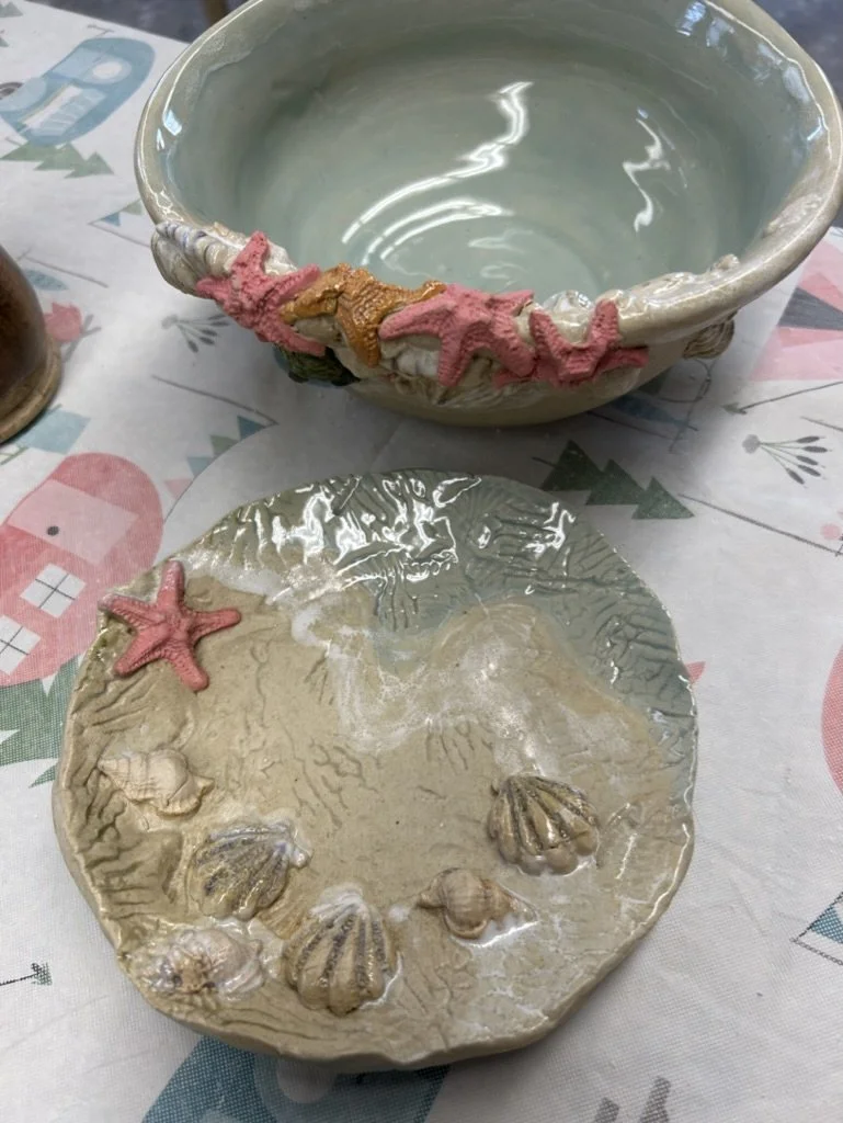 Ceramic bowl and plate with sea-themed designs, featuring starfish and shells.