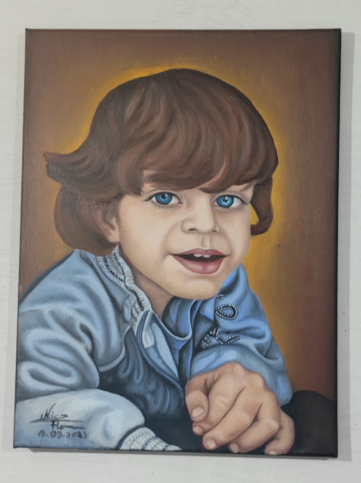 Portrait painting of a young child with brown hair, blue eyes, and wearing a blue sweater, smiling with one hand forward.