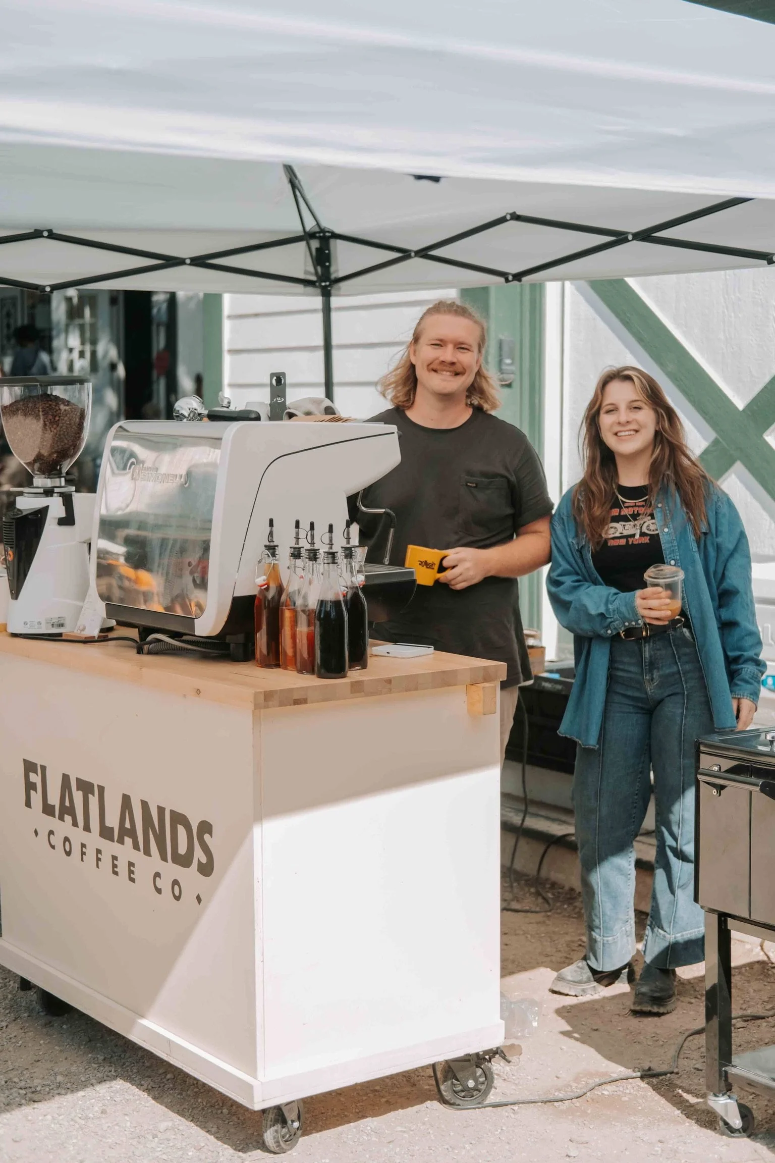 Busy coffee cart line as a barista makes espresso drinks at an event