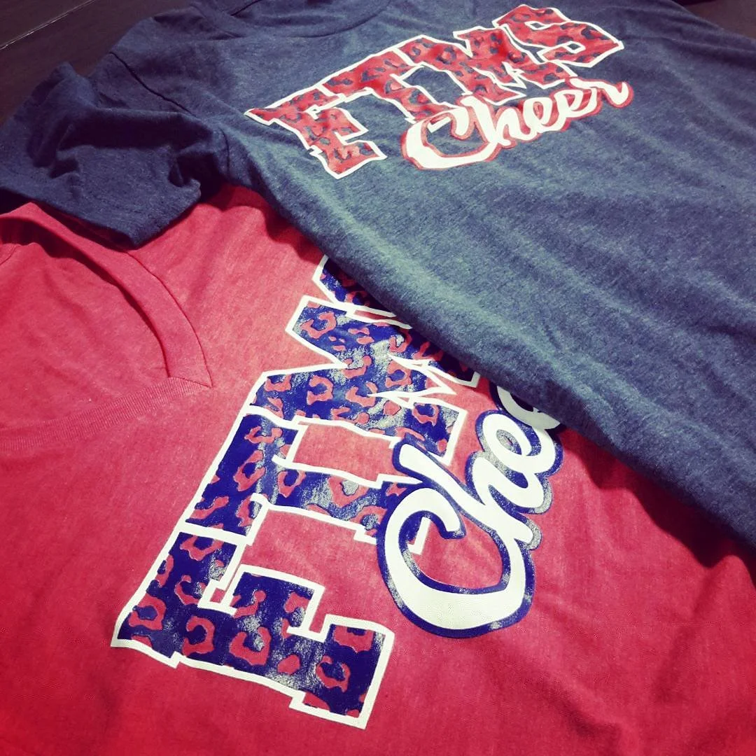 Red and dark gray cheer apparel with coordinating patterned graphics.