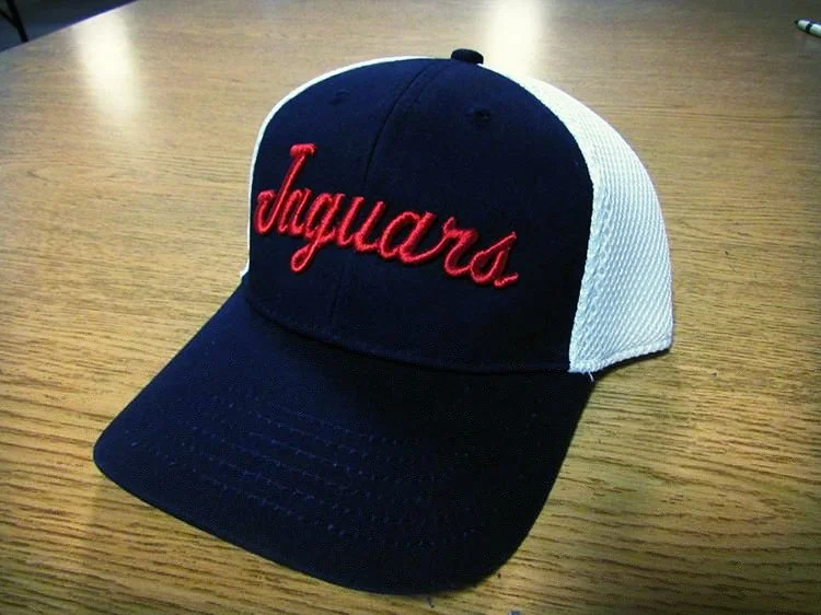 A baseball cap with a navy blue front and white mesh back, featuring the word 'Jaguars' embroidered in red on the front.