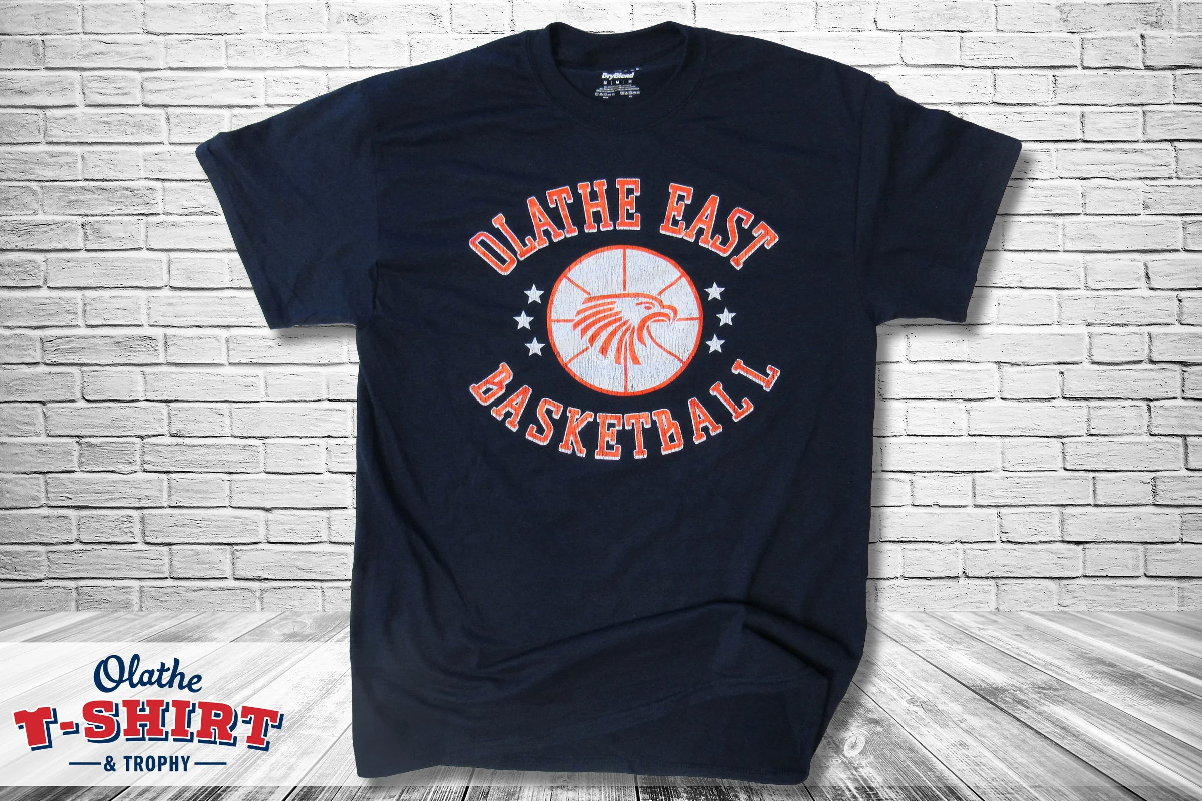 Navy Olathe East basketball shirt with a bird mascot and stars.