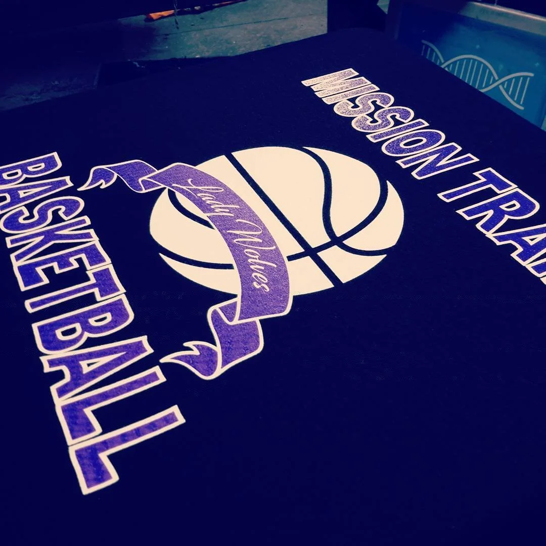 Dark fabric with a white and purple basketball-themed design.