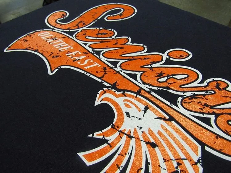 Orange T-shirt with a blue fish-shaped graphic and lettering.