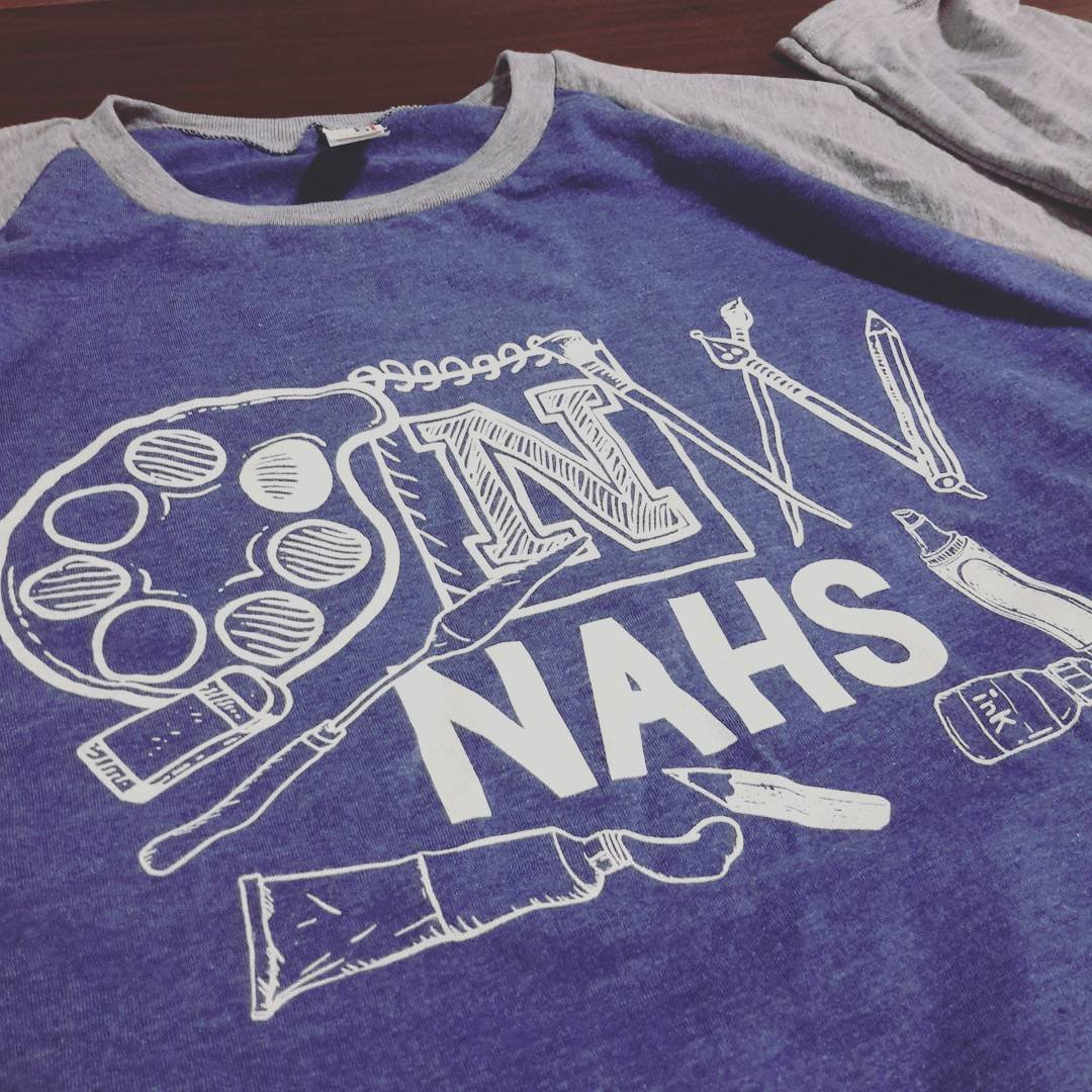 Purple T-shirt with white science-themed graphics and lettering.