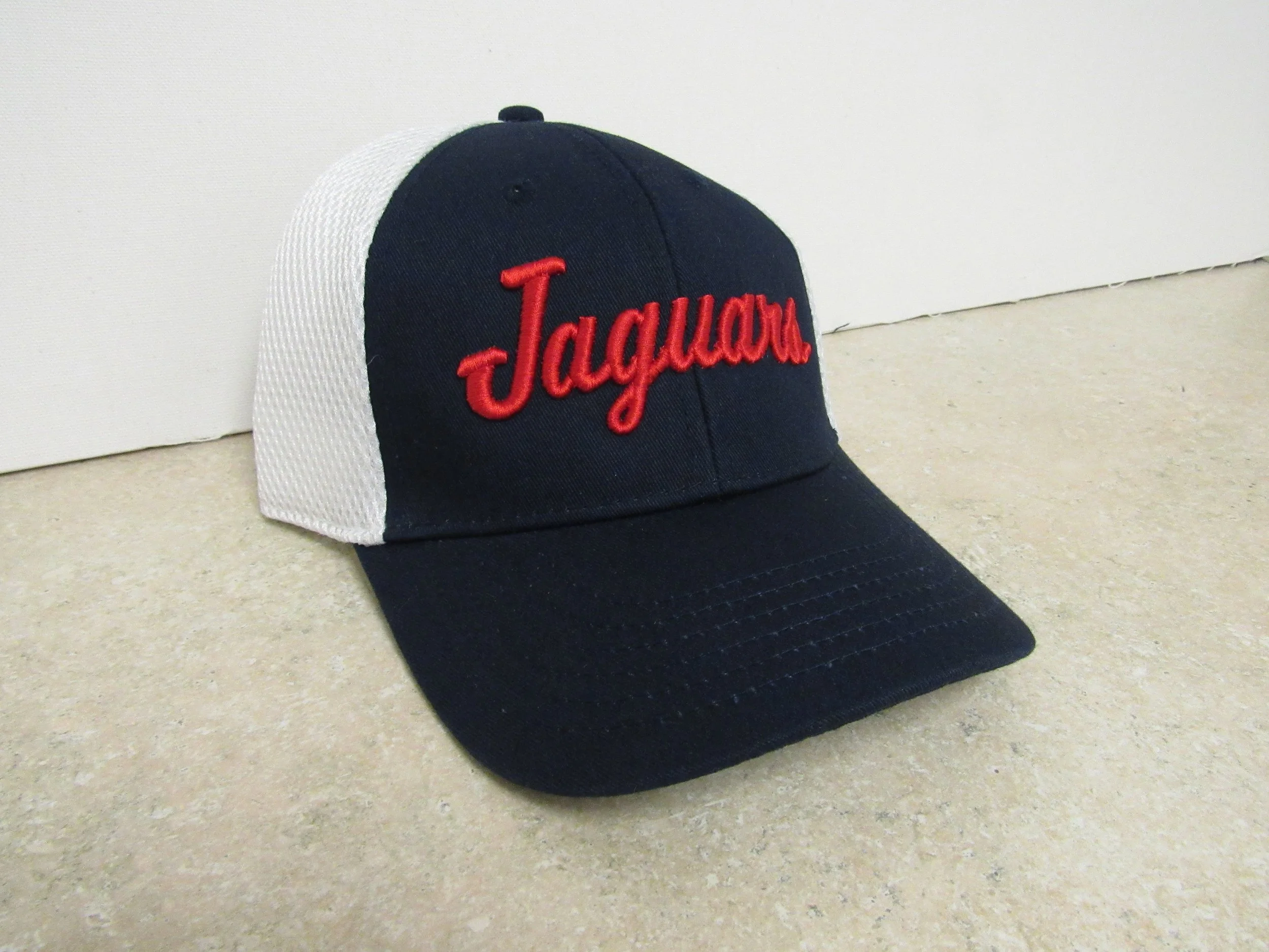 Black and white baseball cap with red script embroidery.