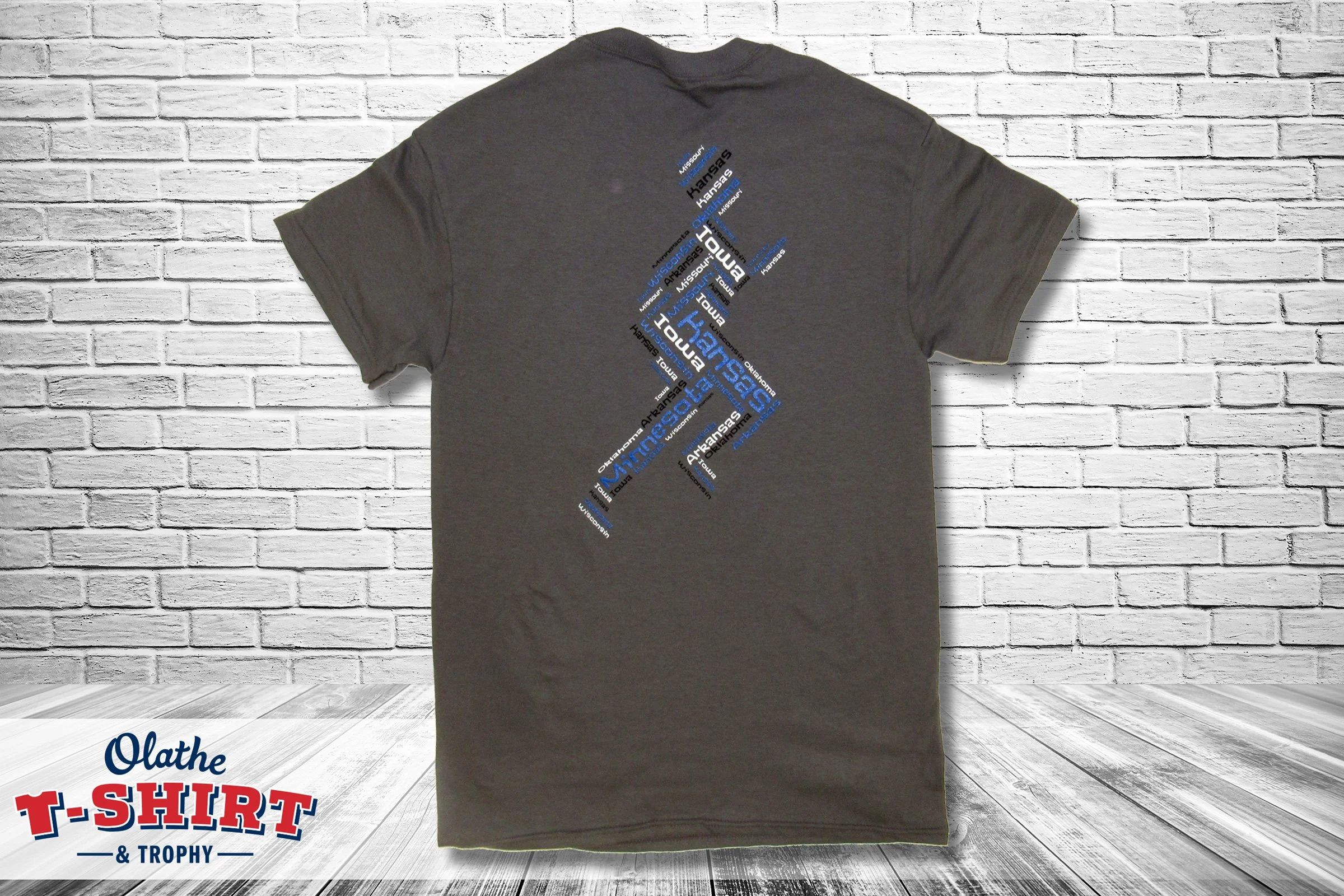 Gray track-and-field championship shirt featuring several team mascots.